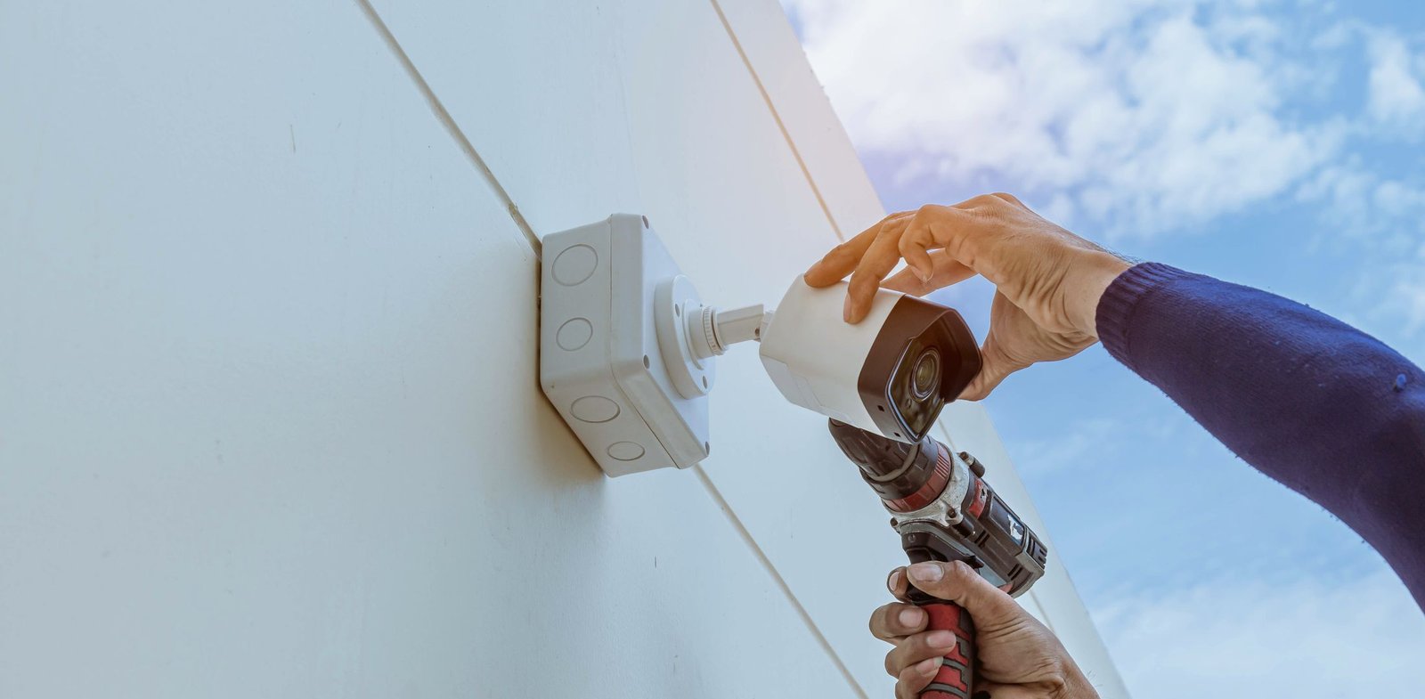 Technician installing a security camera