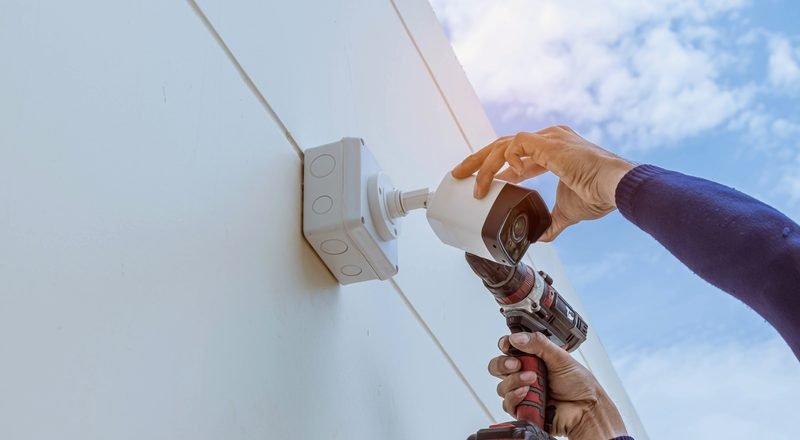 Technician installing a security camera